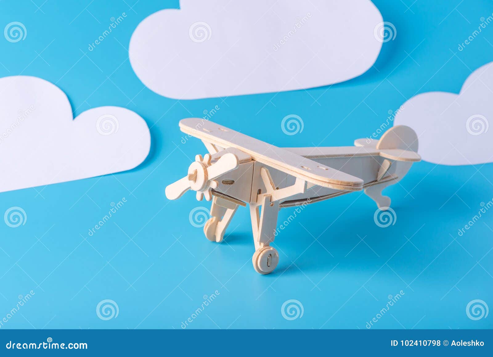 Wooden Toy Airplane on a Background of Blue Sky with Paper Clouds ...