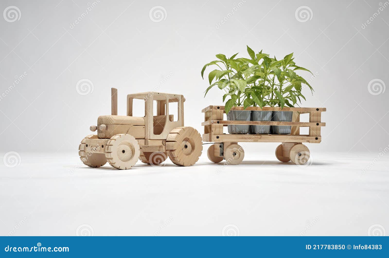 wooden tractor with trailer, transports small trees. concept of safeguarding nature and the environment and deforestation. concept