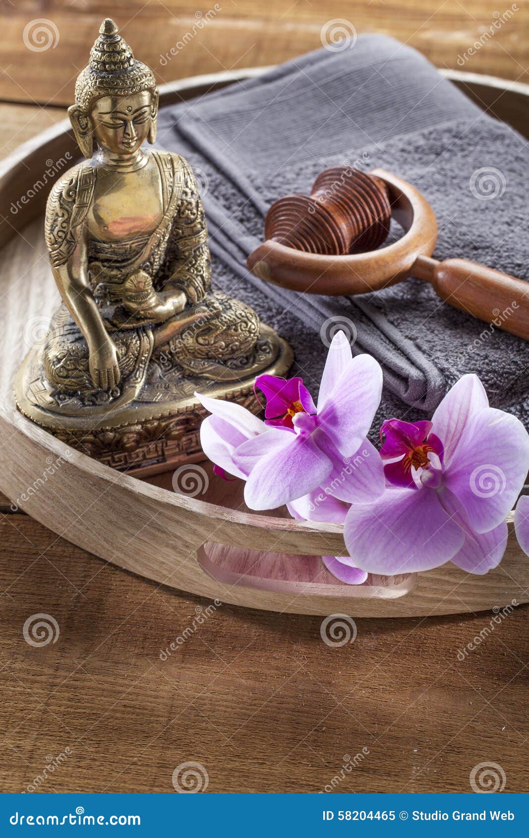 wooden tray with buddha and orchid flowers for spirituality and massage
