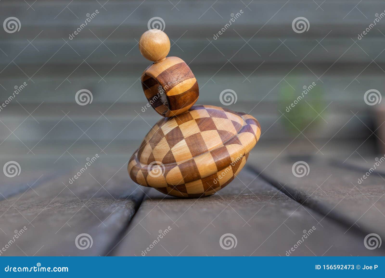 wooden vintage spinning top over a table with blurry background