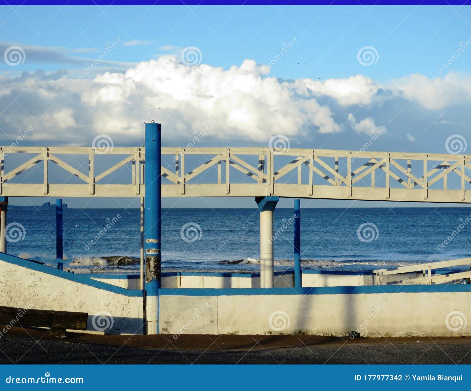 wooden walkway facing the blue sea
