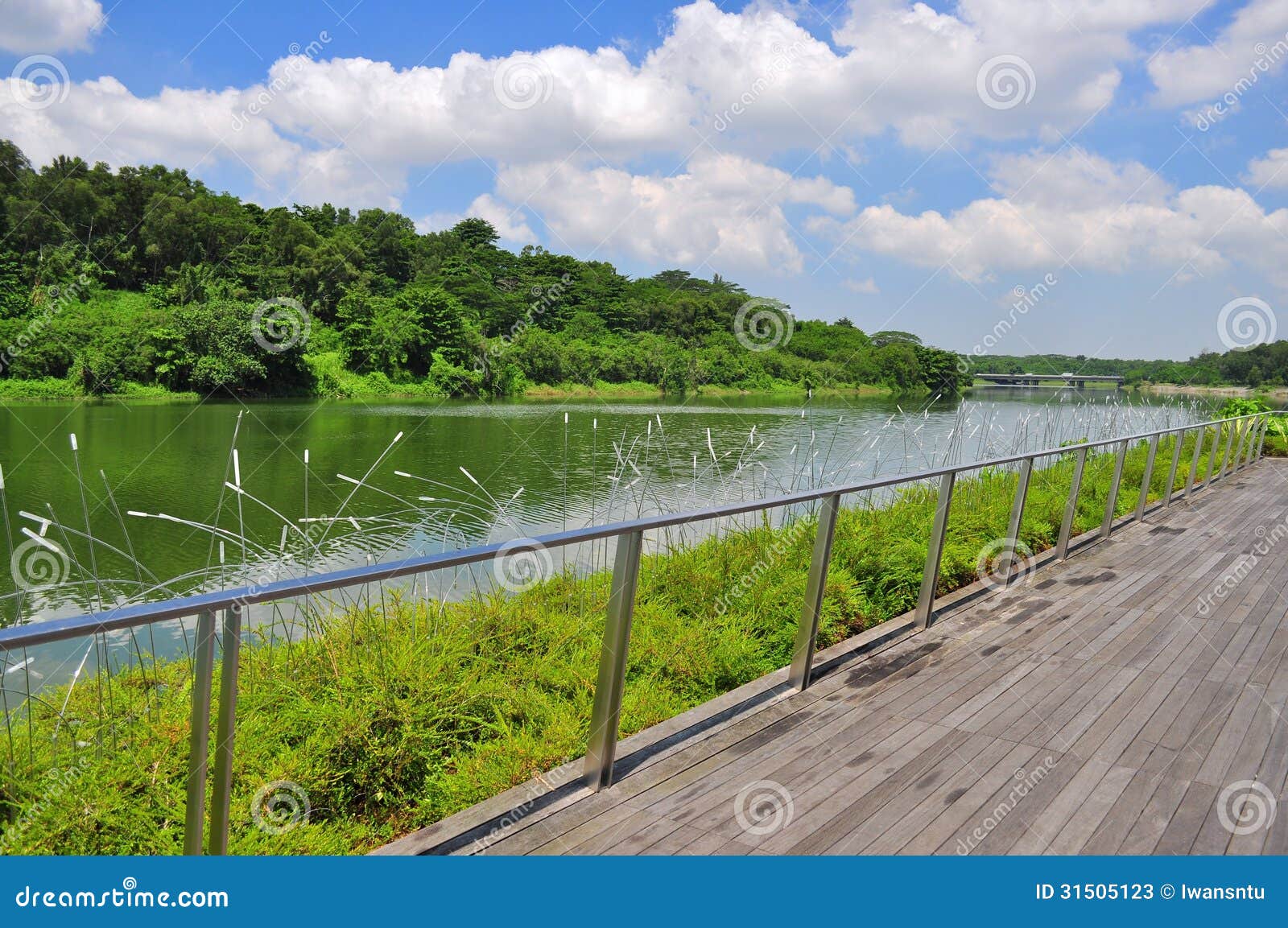 a wooden walkway by the river at punggol waterway