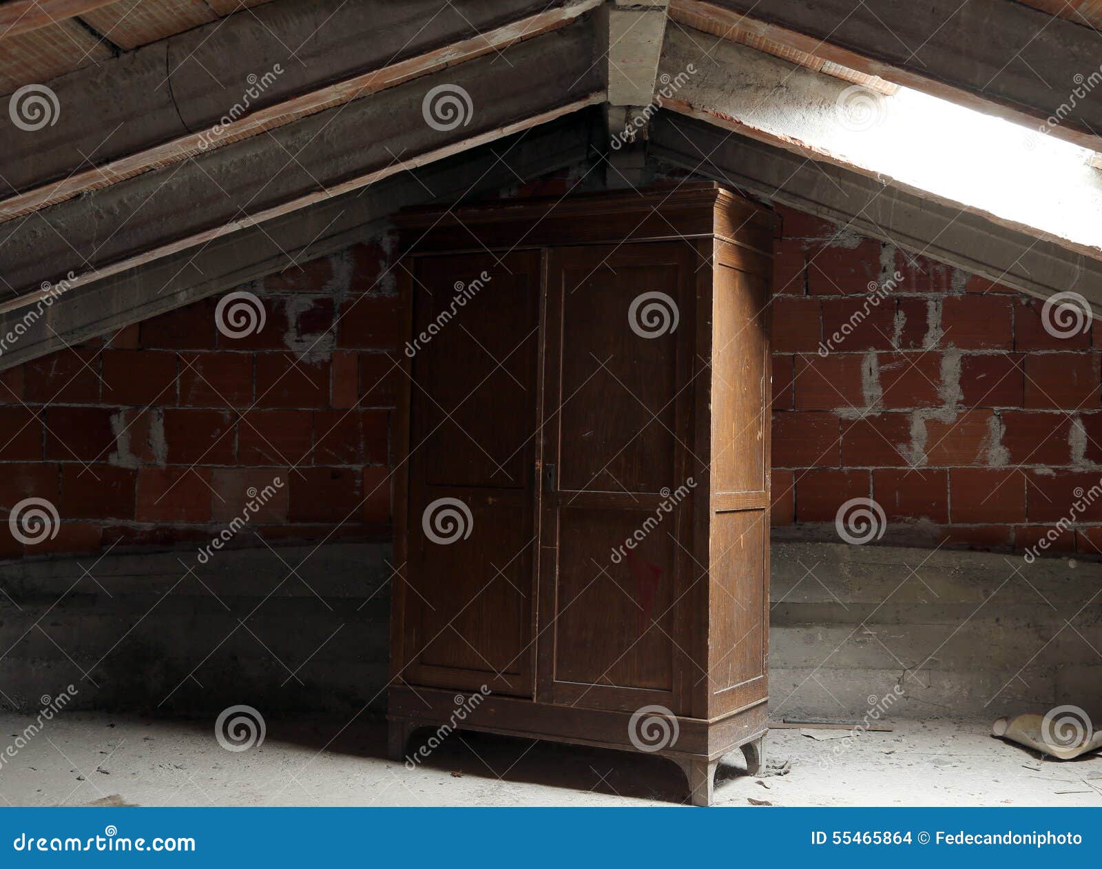 wooden wardrobe in the dusty uninhabited attic