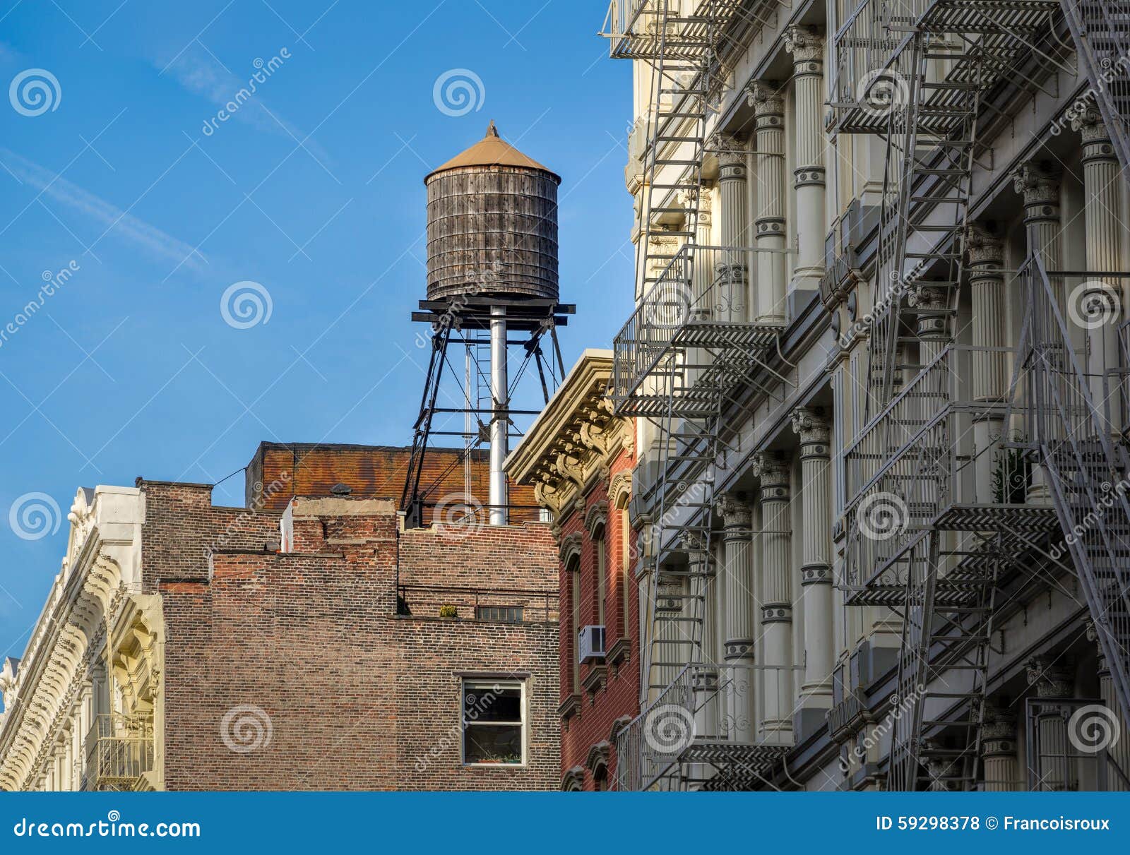 wooden water tank and cast iron facades, soho, new york