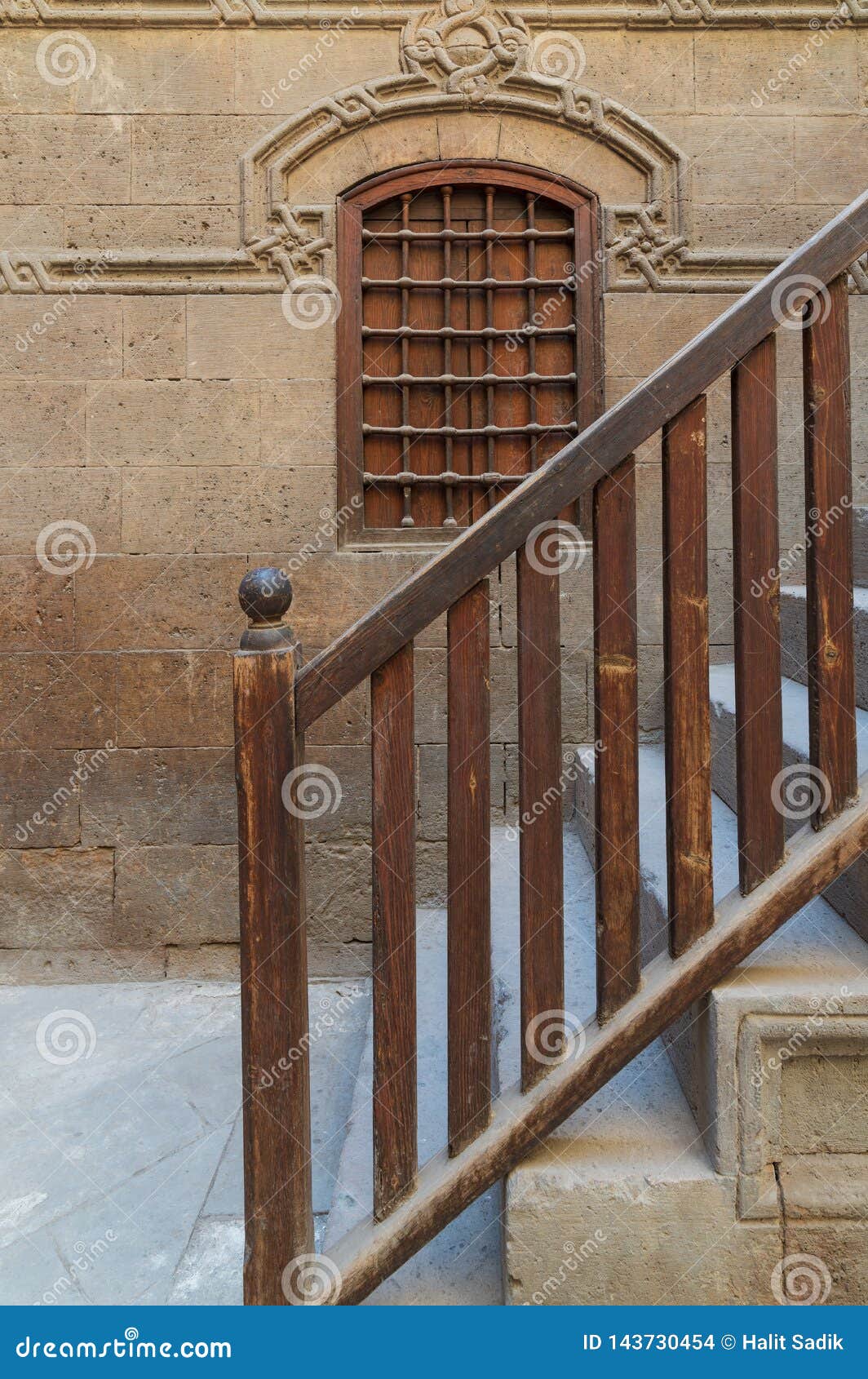 wooden window and staircase with wooden balustrade leading to historic building, old cairo, egypt