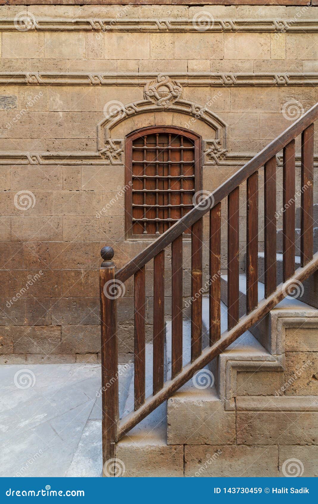 wooden window and staircase with wooden balustrade leading to historic building, old cairo, egypt