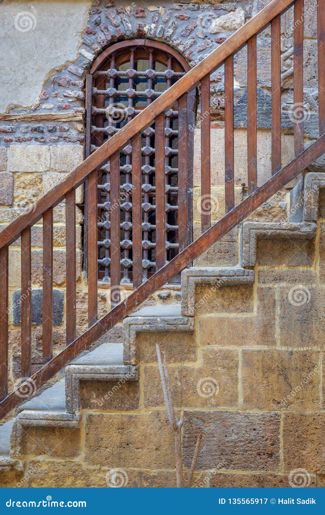 wooden window and staircase with wooden balustrade leading to historic beit el set waseela building, old cairo, egypt
