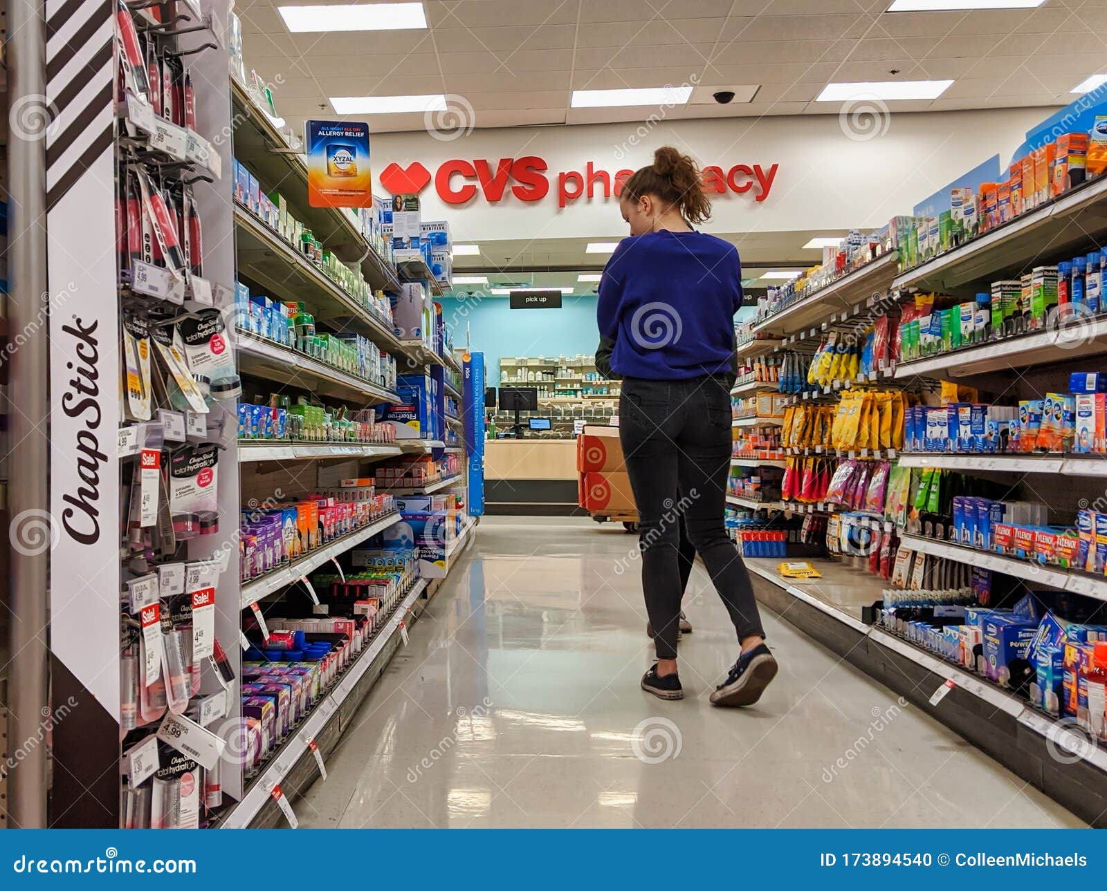 Woman Browsing Medicine and Supplements in the CVS Pharmacy Inside a ...
