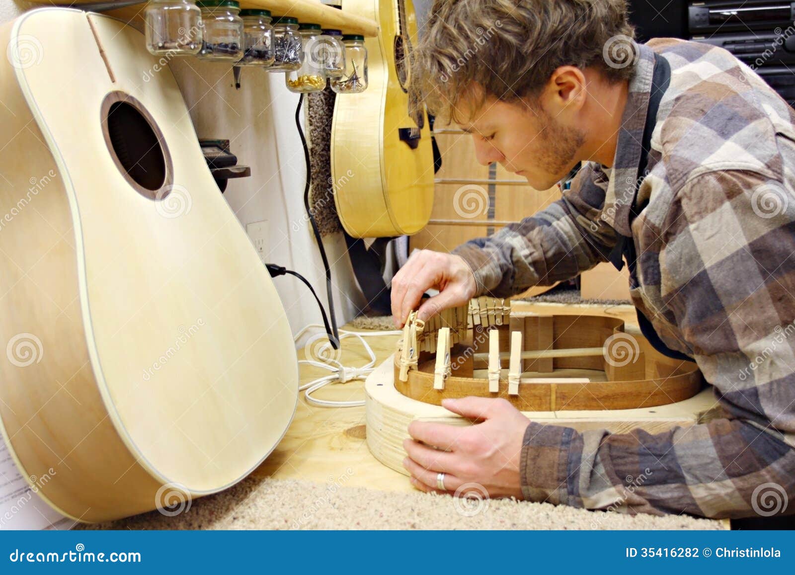 Woodworker Building Guitar In Workshop Stock Photography 