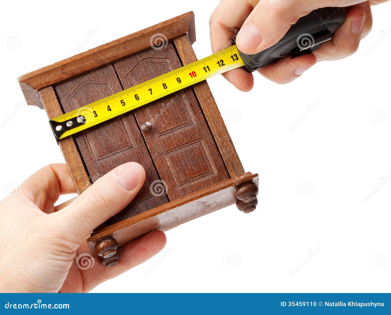 Woodworker Measuring Wardrobe With A Tape Measure 