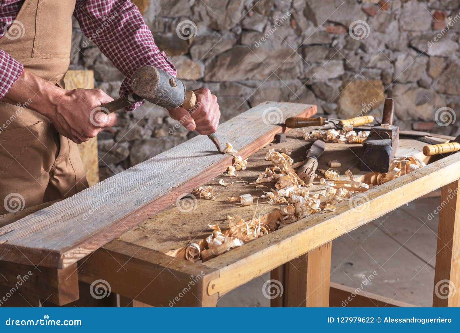 woodworker using chisel to smooth down wood