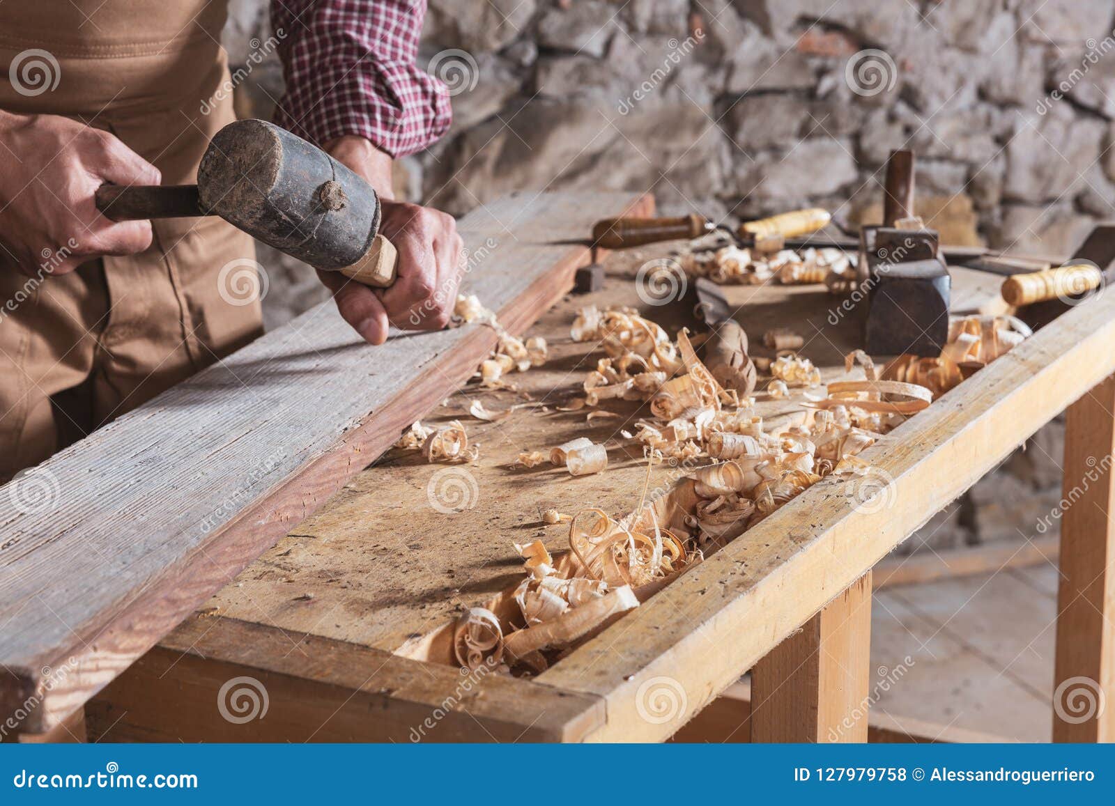 woodworker using chisel to smooth down wood