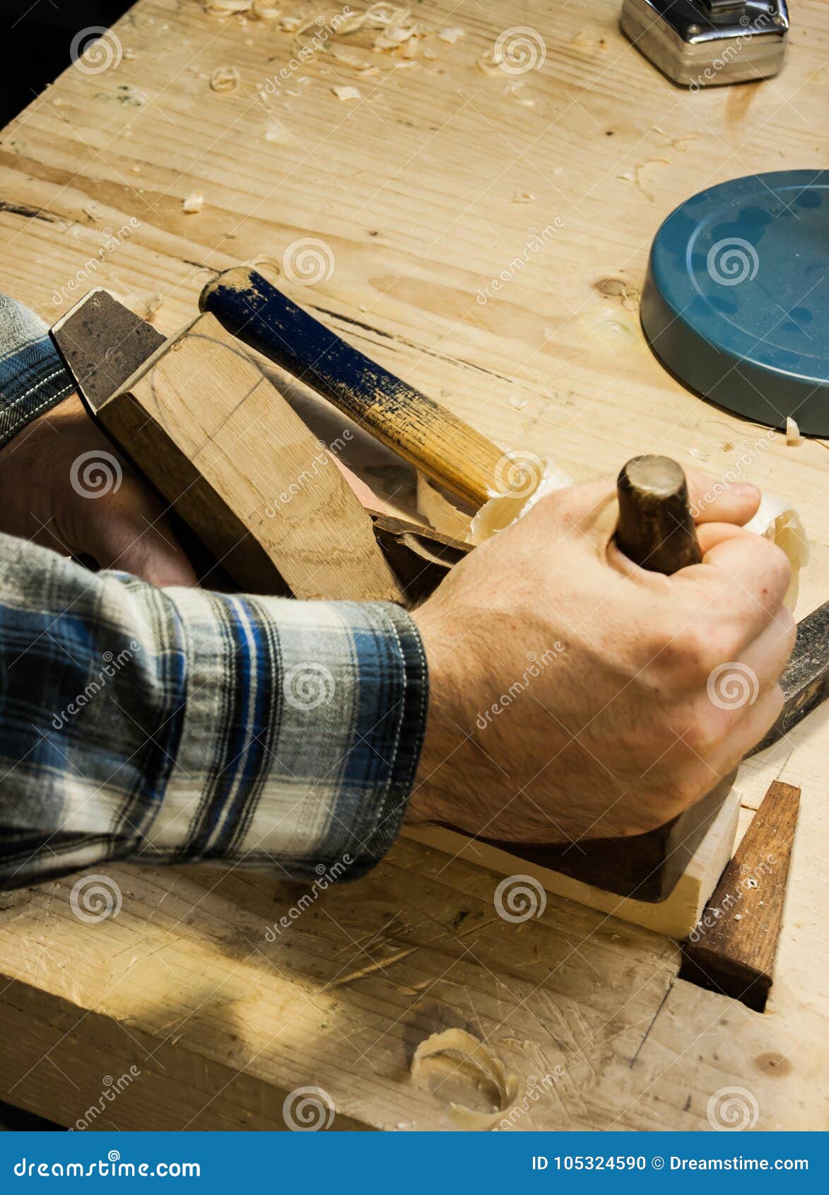 woodworkers hands on an old fashion hand plane