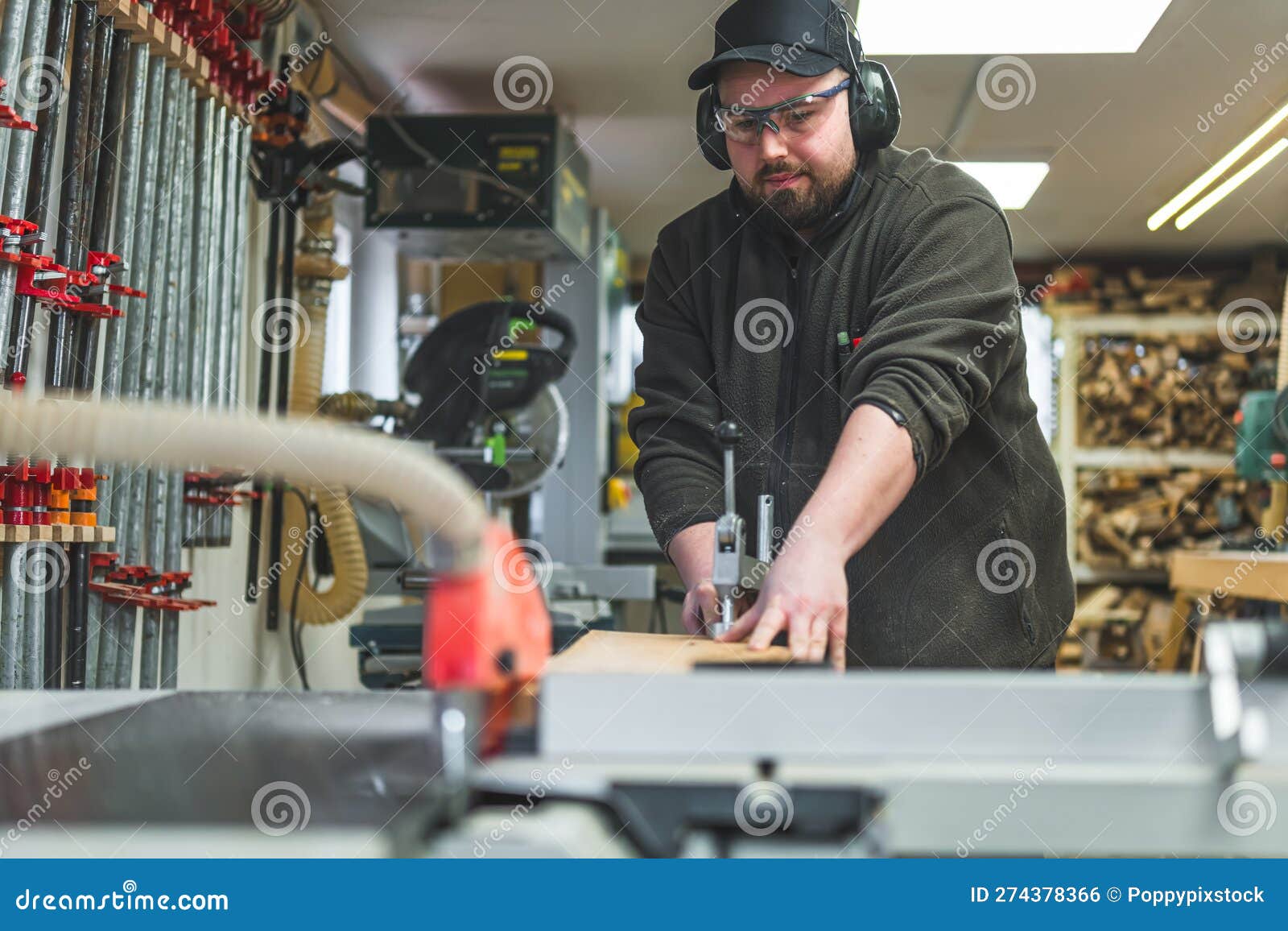 Woodworking Interior. Focused Craftsman in Protective Eyewear