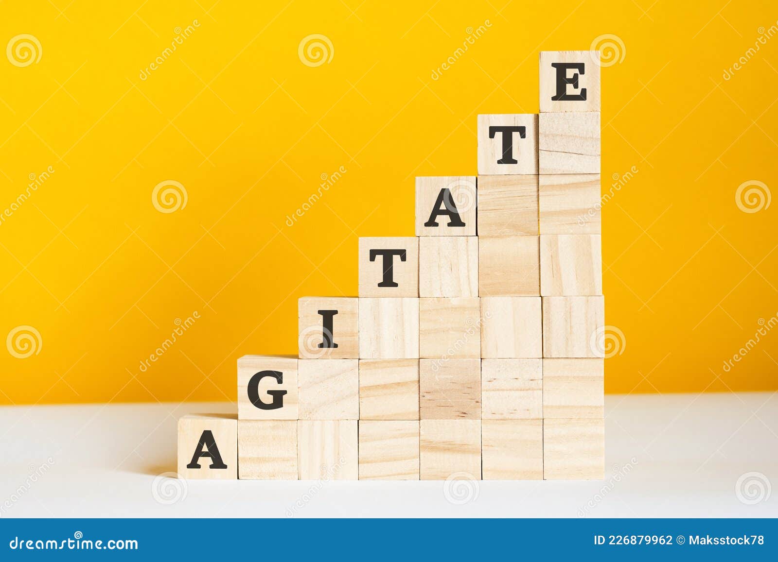 the word agitate is written on a wooden cubes, concept