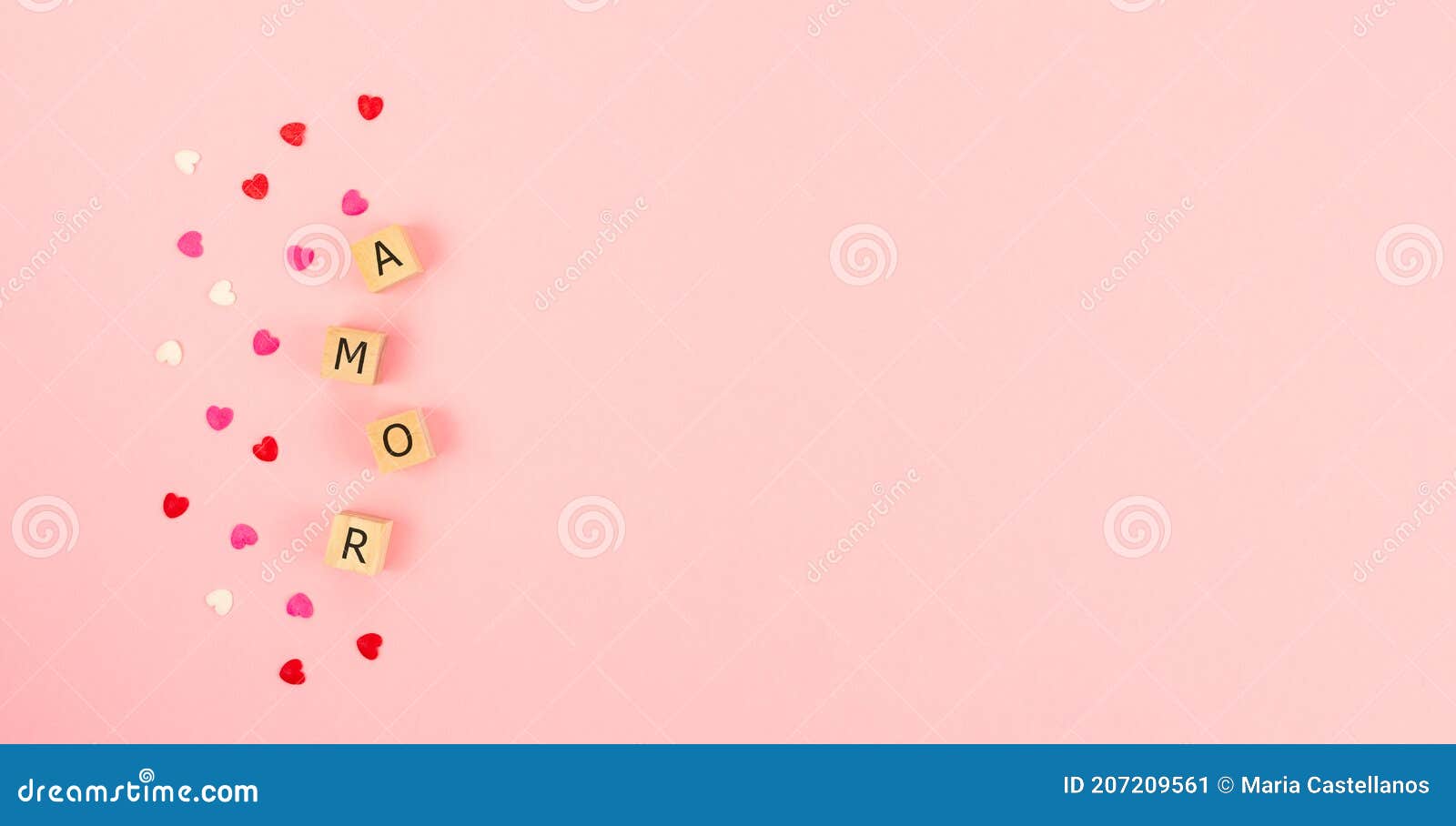 word amor on wooden cubes in a pink background. copy space