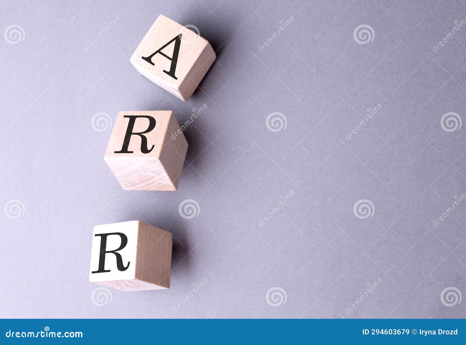 word arr on wooden block on the grey background