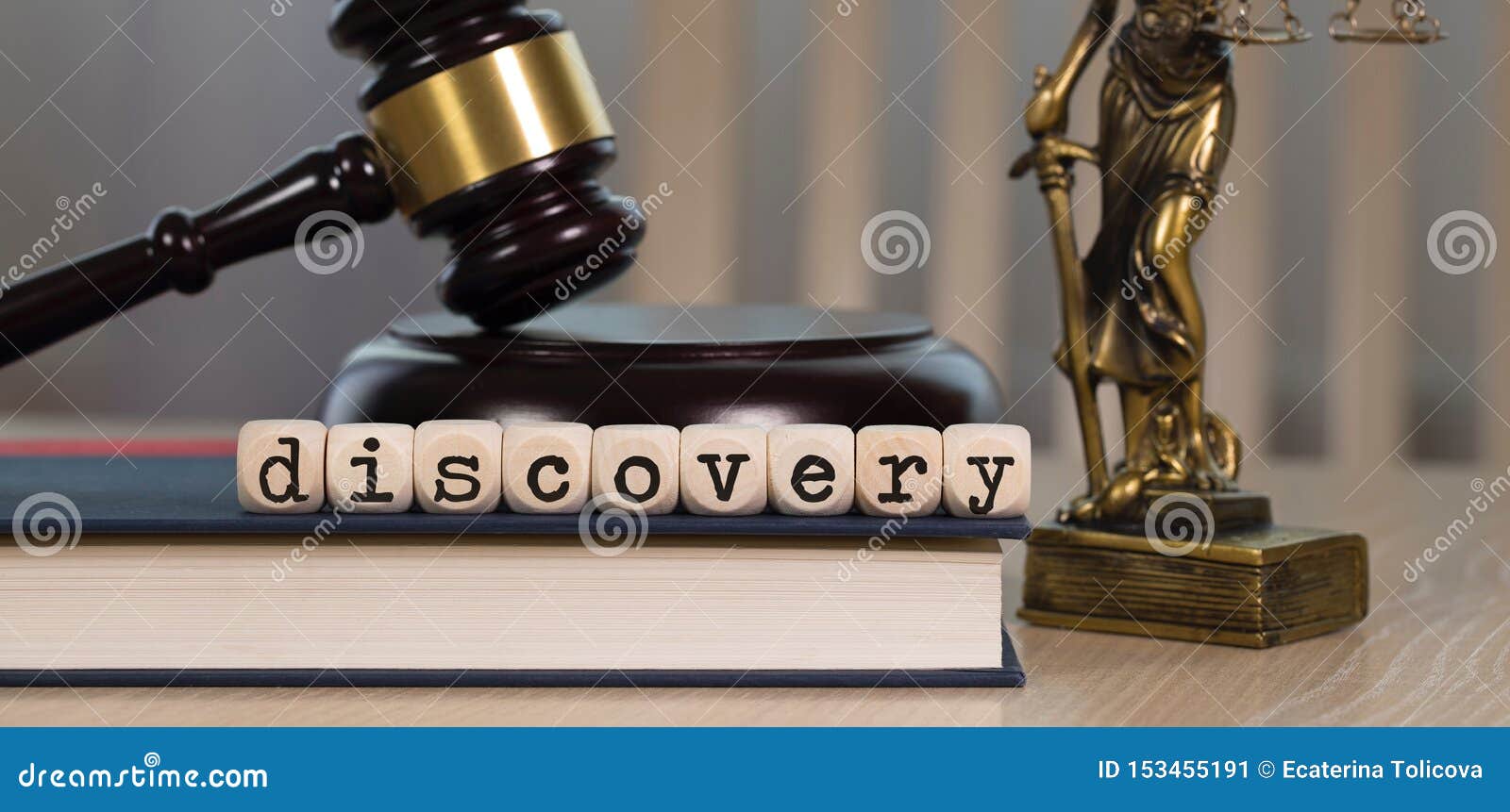 word discovery composed of wooden dices. wooden gavel and statue of themis in the background