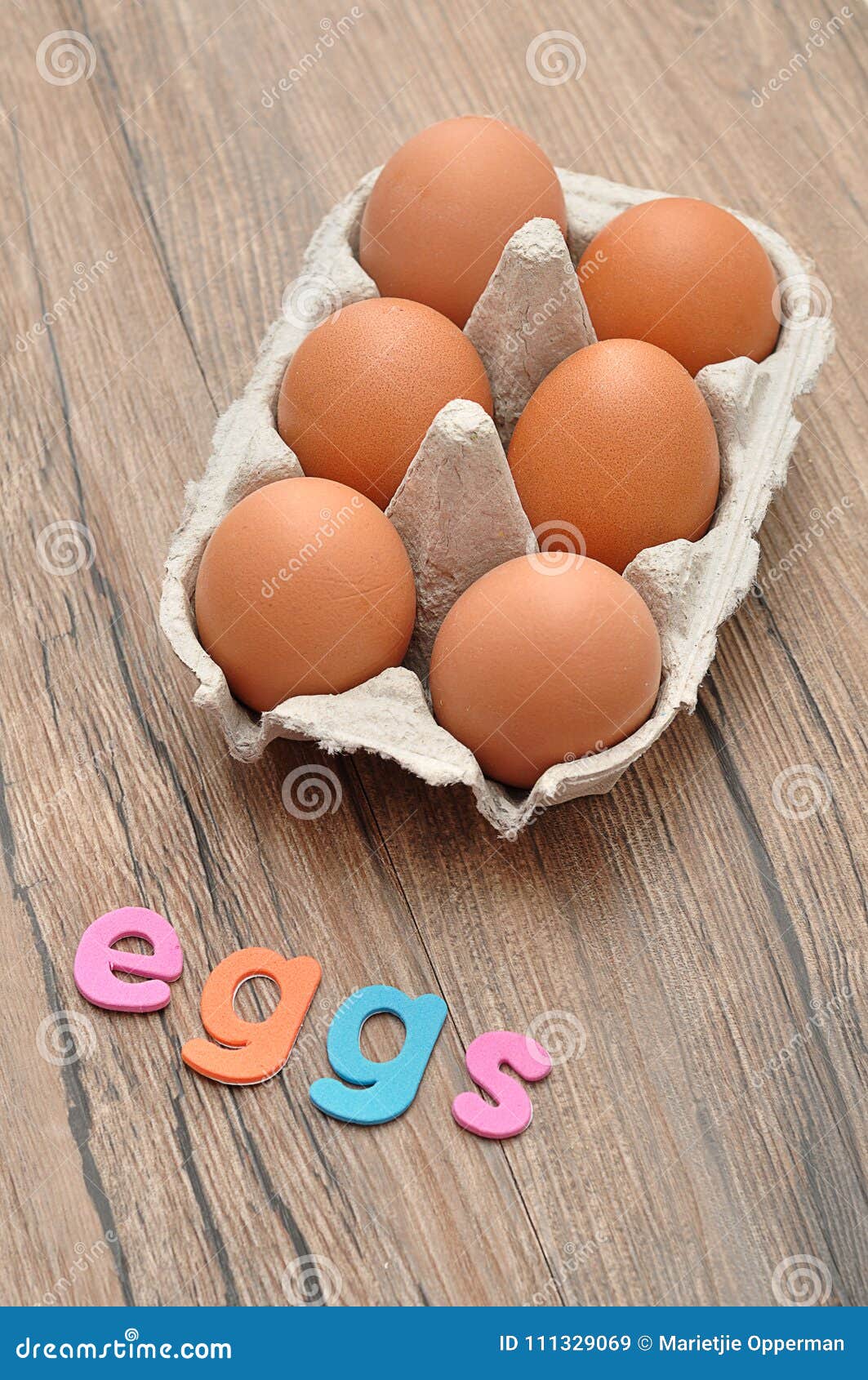 The Word Eggs Displayed with Chicken Eggs in a Egg Box Stock Image