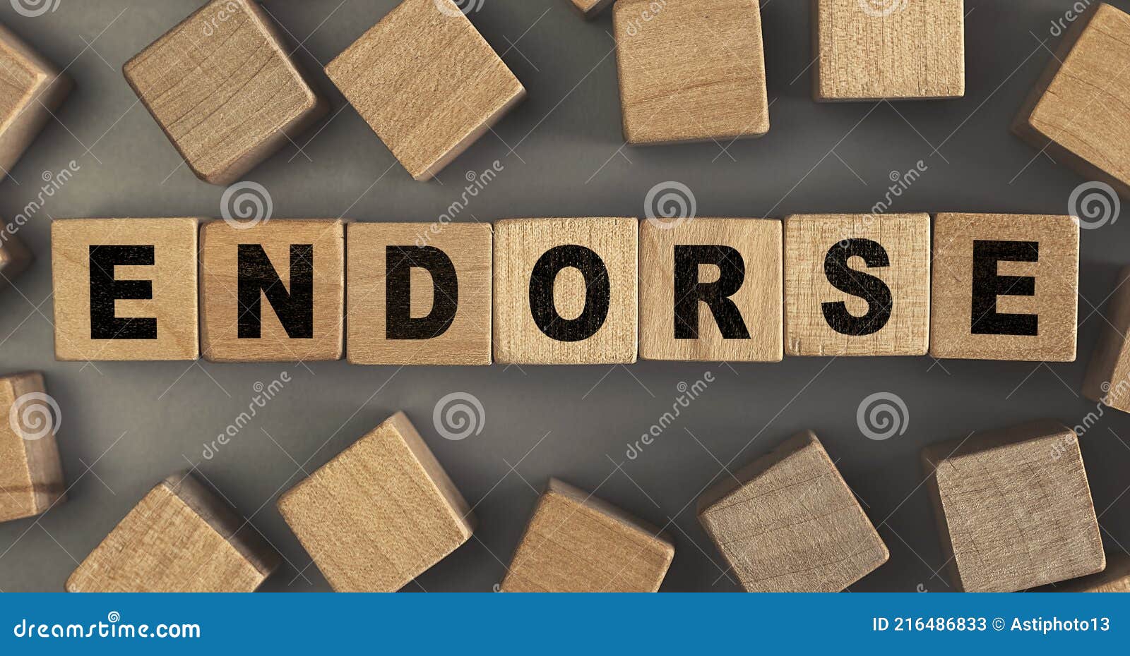 the word endorse on small wooden blocks at the desk. top view