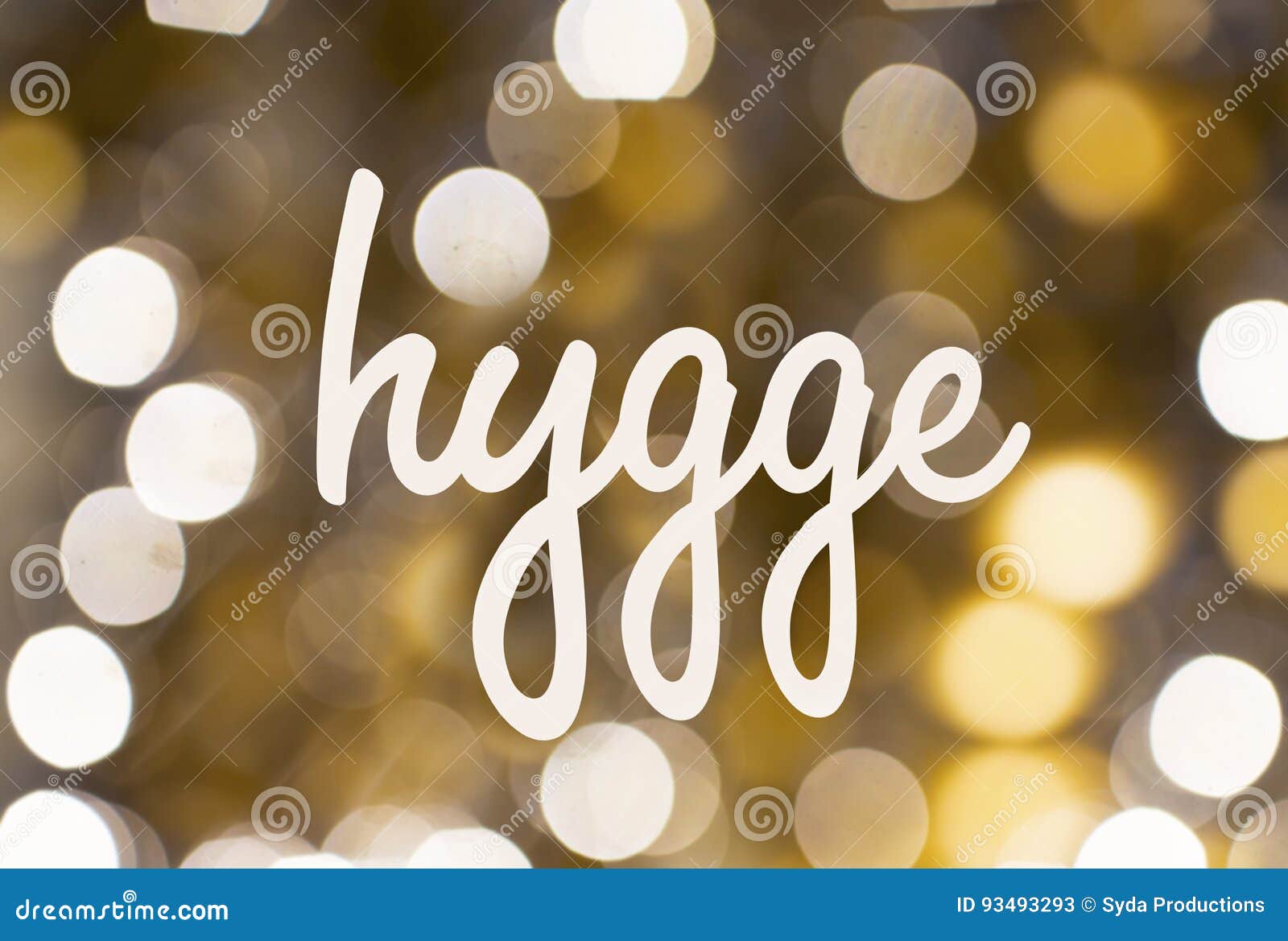 word hygge over blurred golden lights background