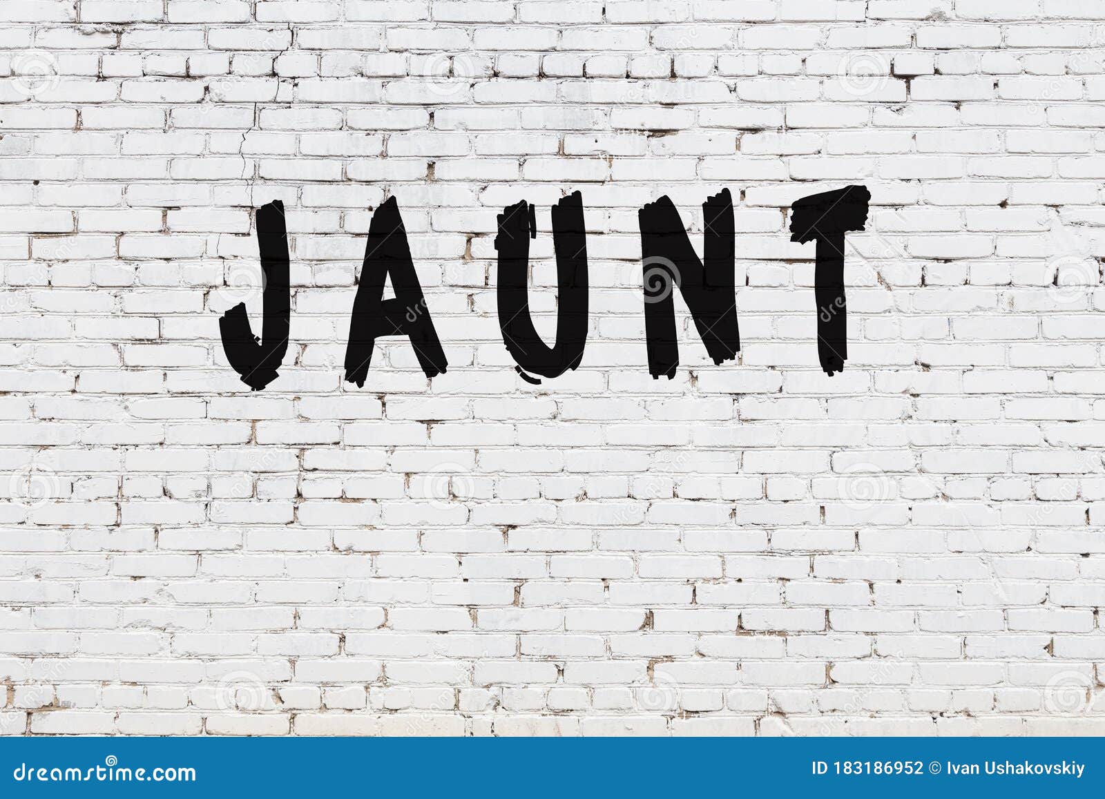 word jaunt painted on white brick wall