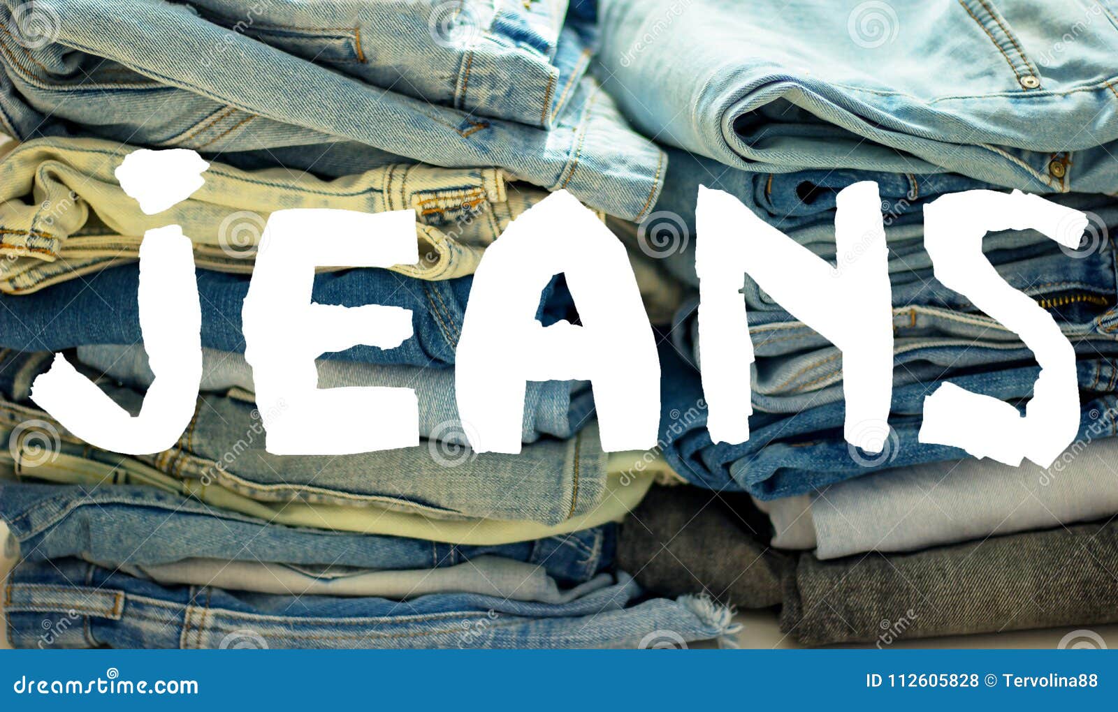 Word Jeans White on the Background of a Stack of Multicolored Jeans