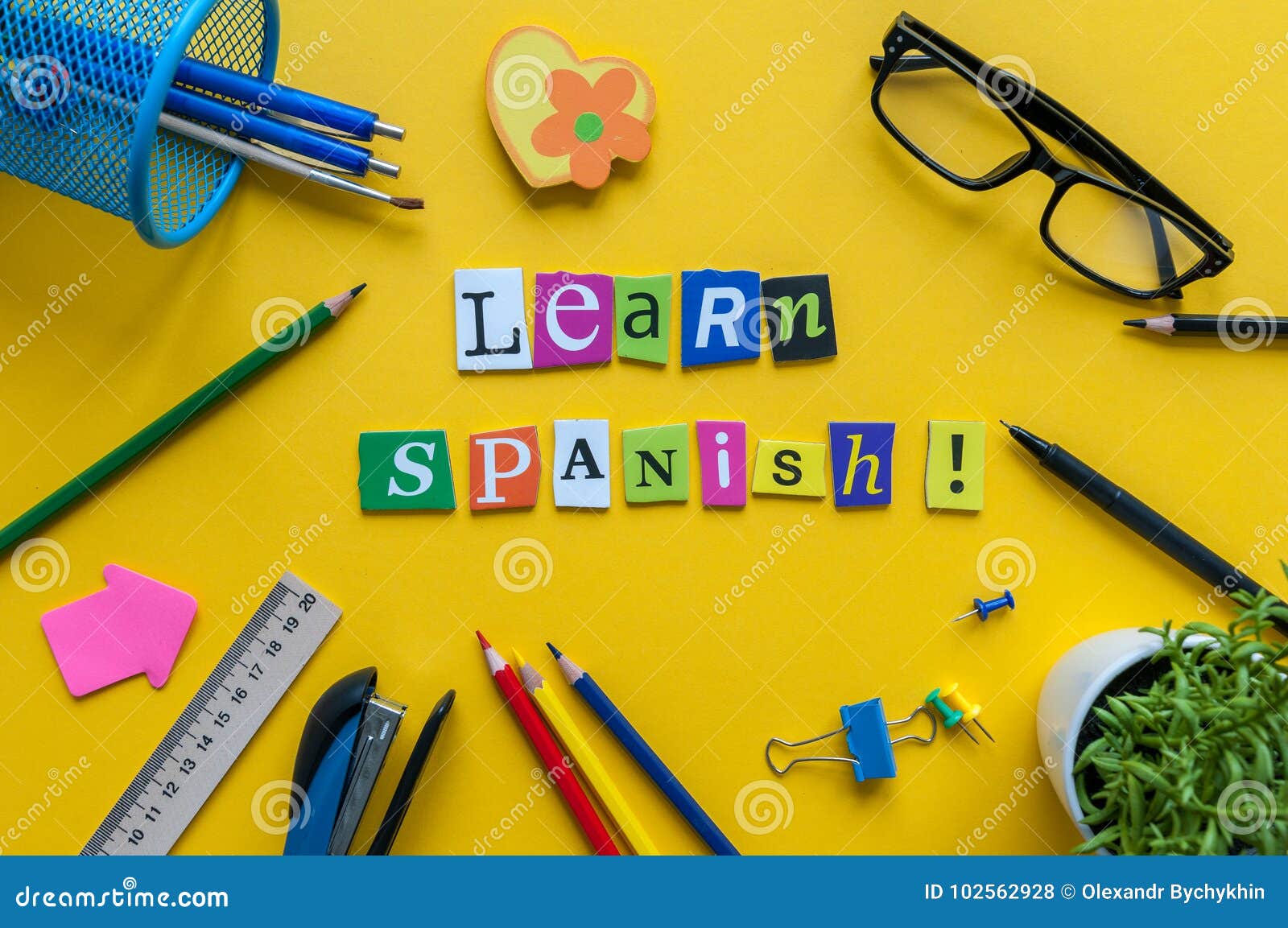 Word Learn Spanish Made With Carved Letters On Yellow Desk With