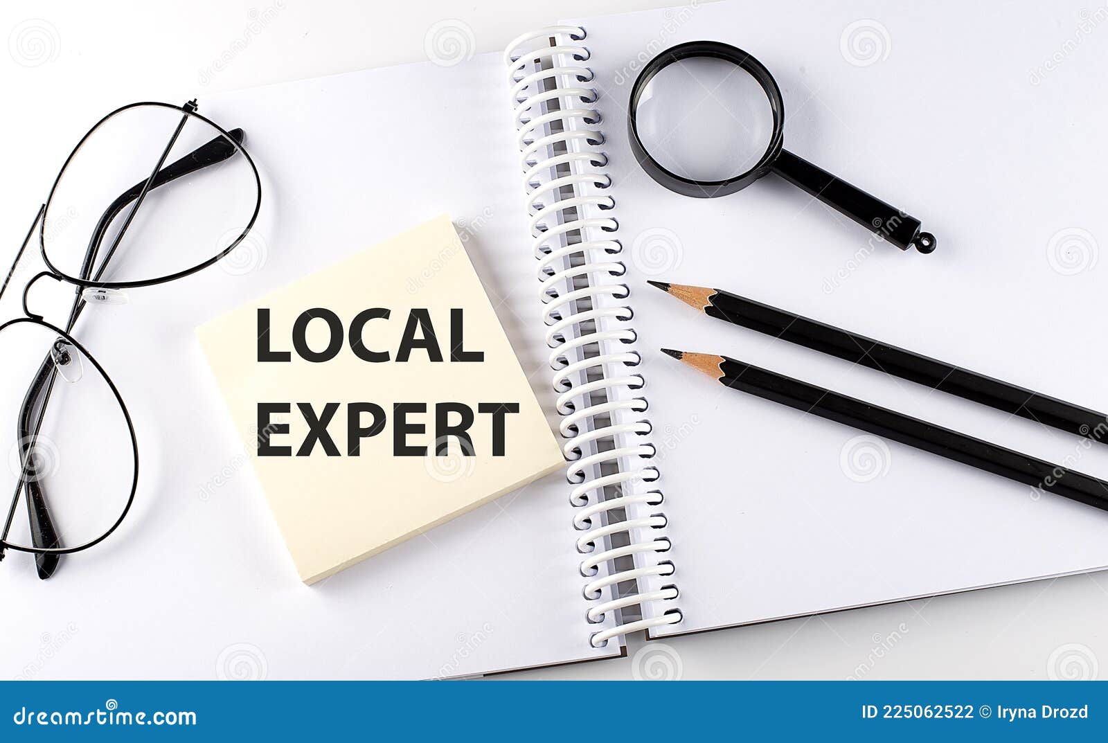 word local expert on the sicker on the notebook with pencils,magnifier and glasses