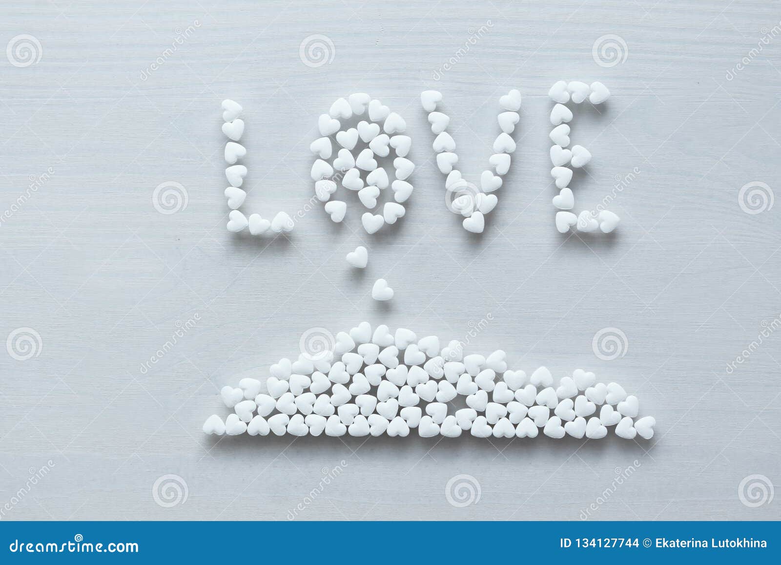 The Word Love is Lined or Written from White Hearts on a White