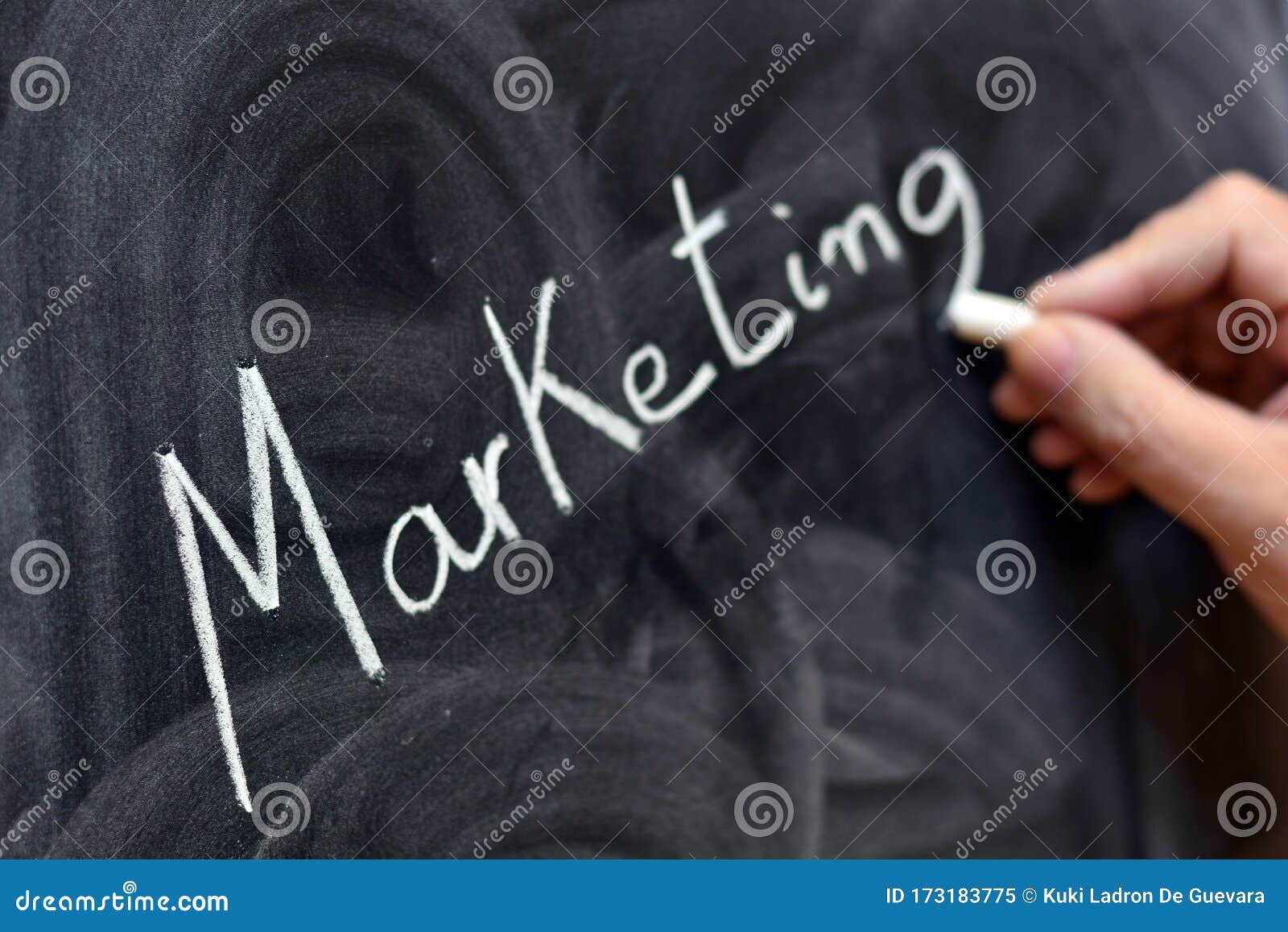 the word marketing written with a chalk on the blackboard