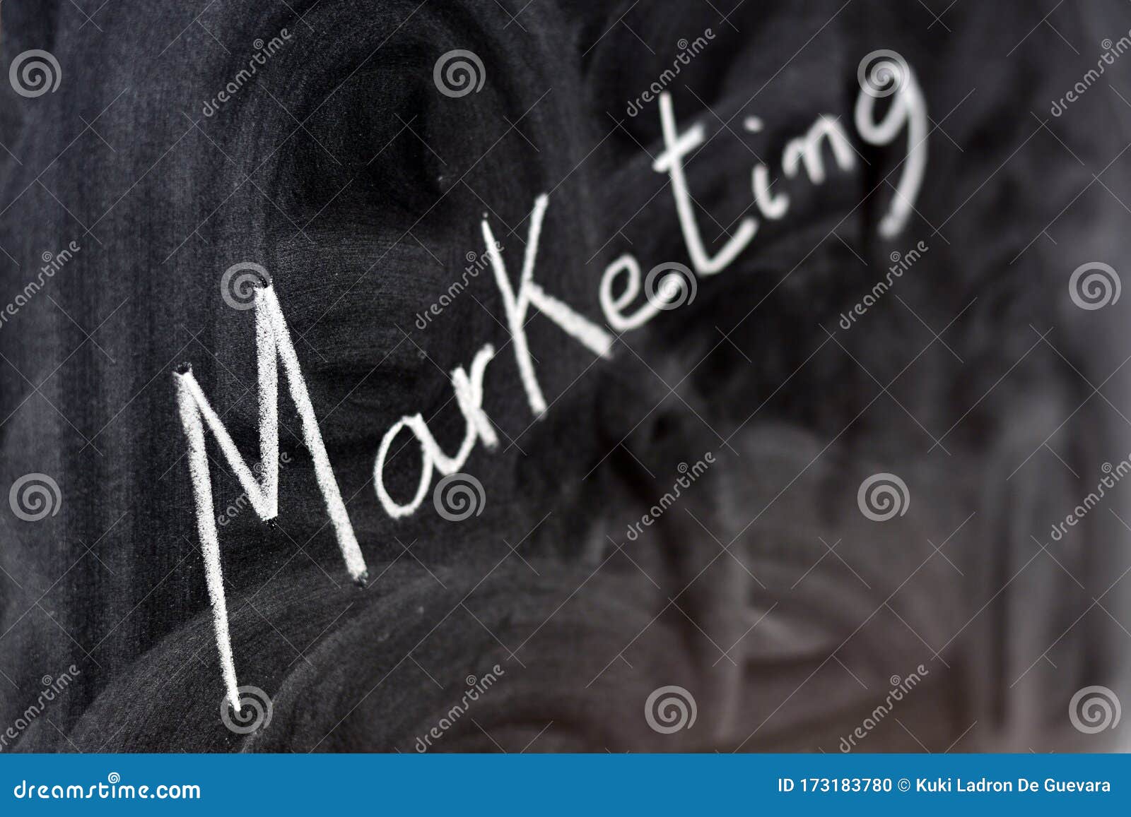 the word marketing written with a chalk on the blackboard