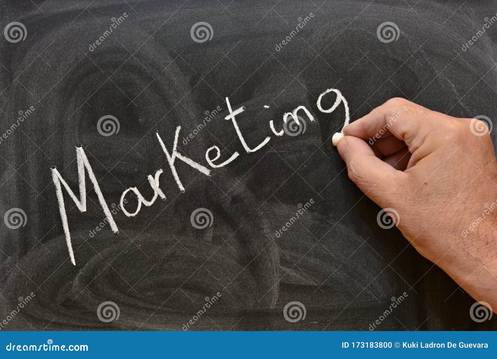 the word marketing written with a chalk on the blackboard