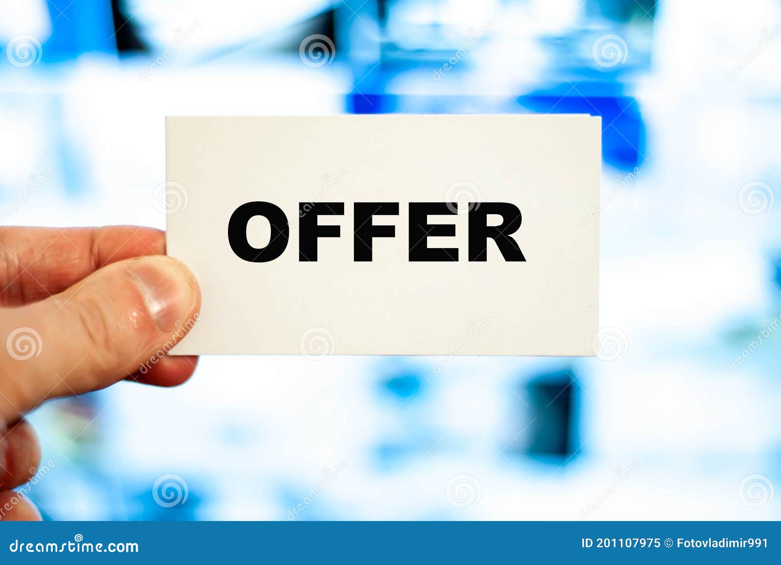 The Word offer in Large Letters on a Business Card in Hand. Business