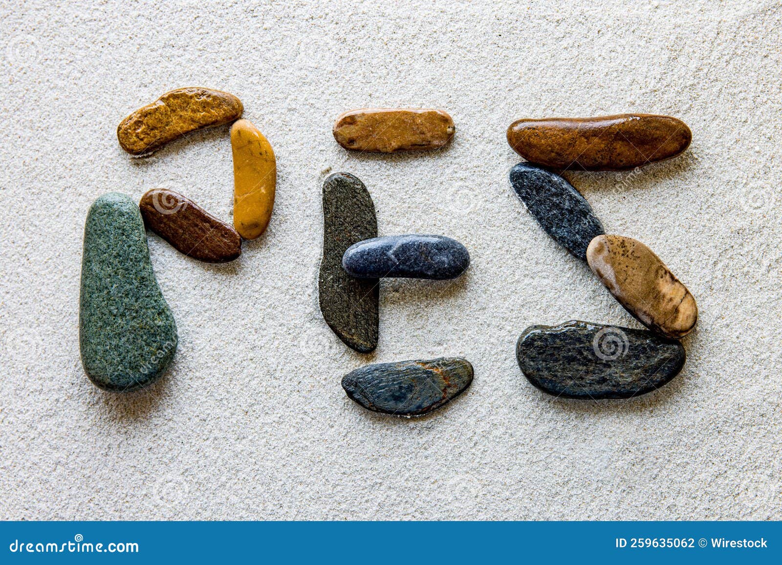 word pez is written using colored stones on a white grainy surface
translation: fish