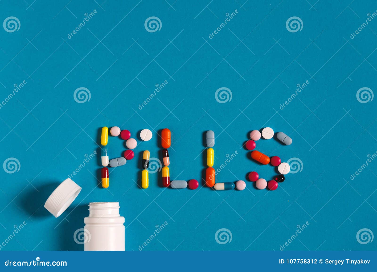 Word Pills With Colored Pills And Tablets On A Blue Background
