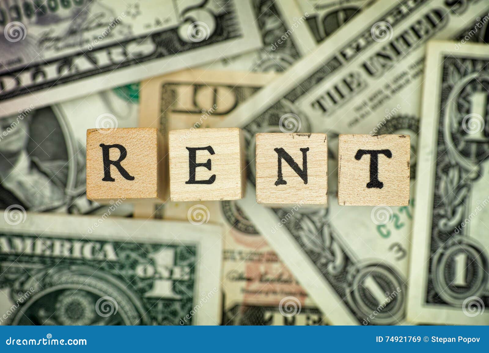Word RENT on dollar bills stock image. Image of wooden 74921769