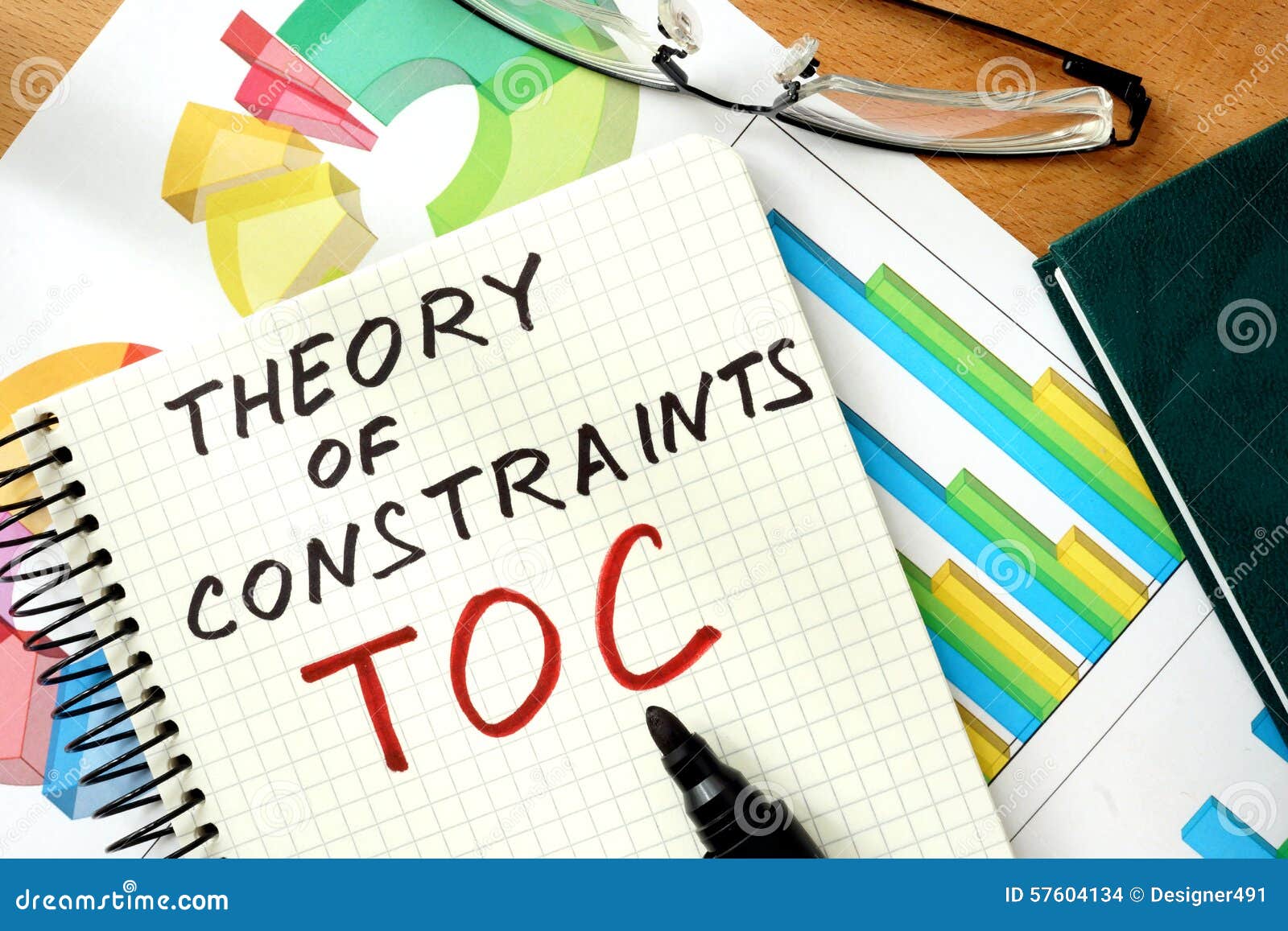 words-theory-of-constraints-toc-on-the-notepad-and-charts-stock-photo