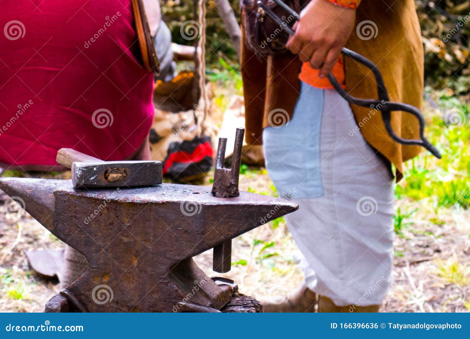 The Work on the Anvil, Vintage Blacksmith Hammer and Tongs Stock Photo