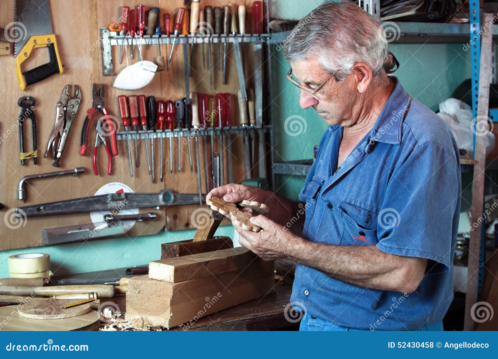 Work Cabinetmaker Looking Handcrafted Wooden Pieces In Garage At