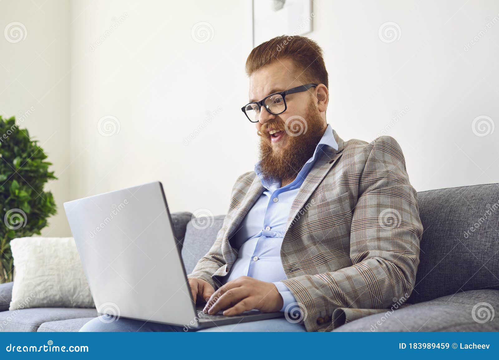 Work Online. Funny Bearded Man in Glasses Laughing Working Online ...