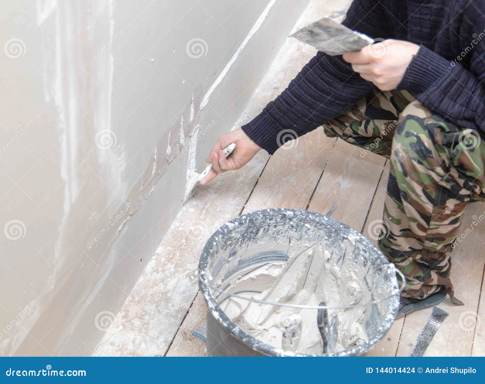 Worker Aligns The Walls With Plaster Repair In The House