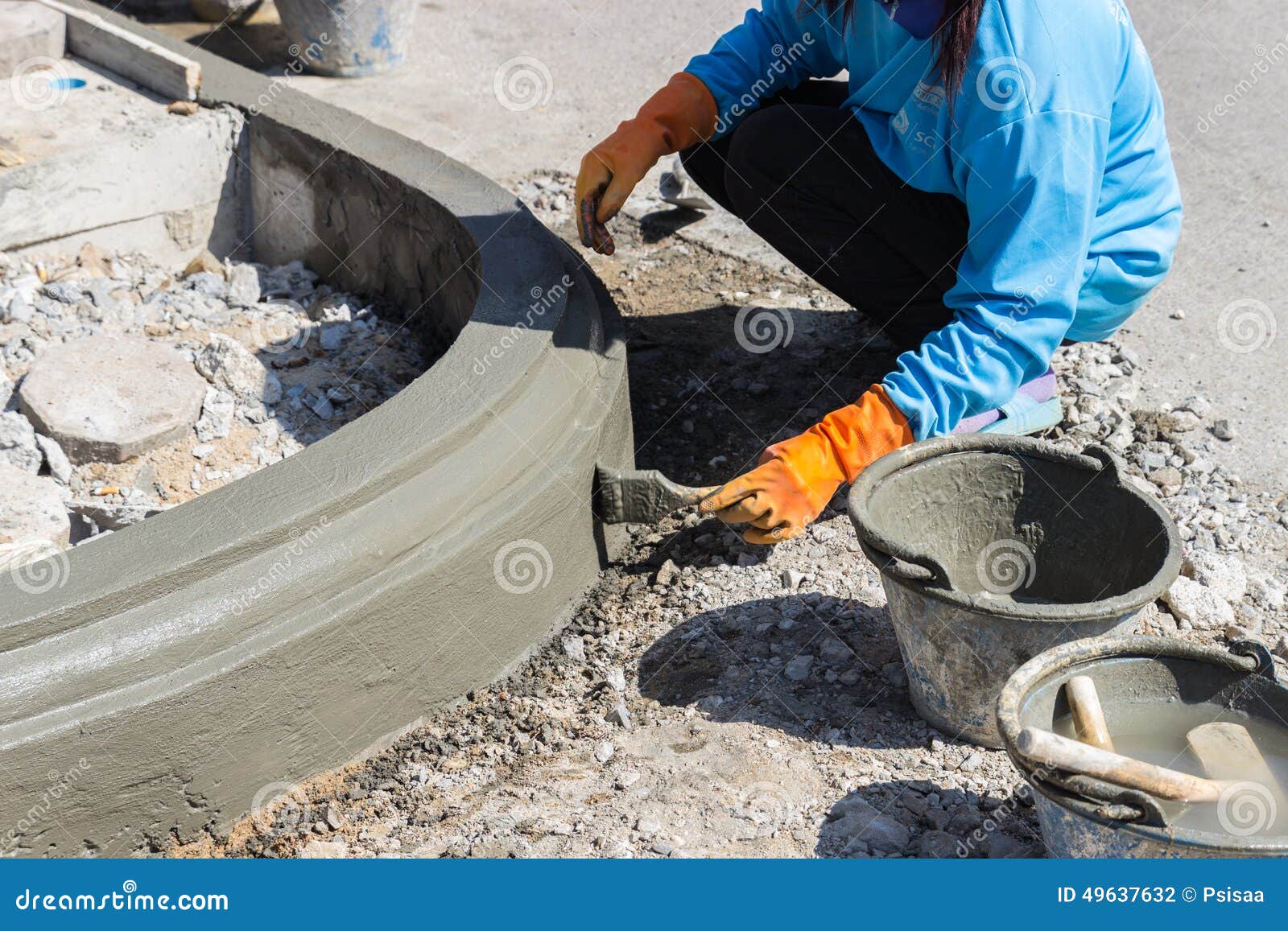 The Worker Apply Cement Over the Surface of Footpath Edge Editorial