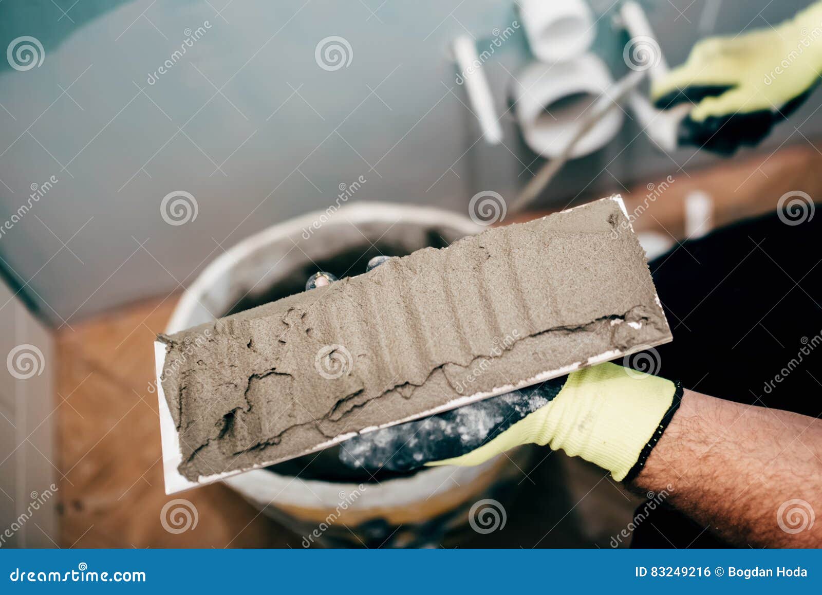 Worker Applying Mortar on Ceramic Tiles and Working on Rebuilding a