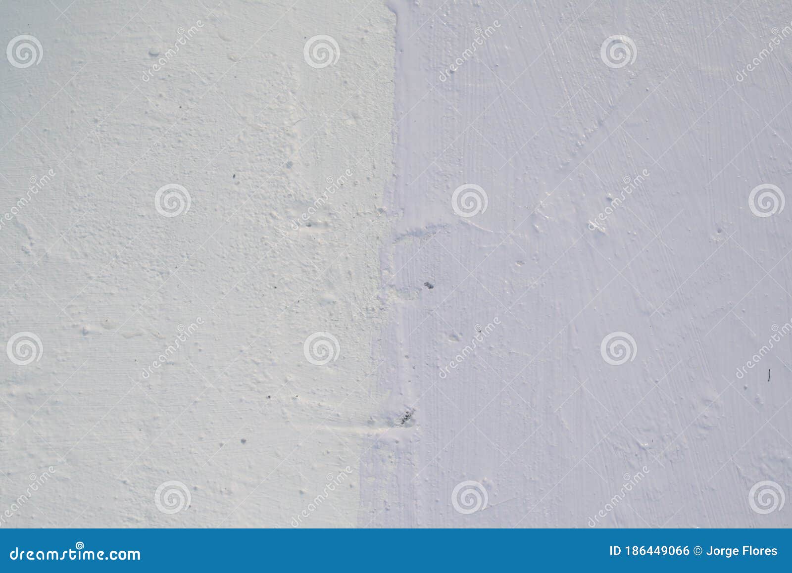 worker applying white roof coating