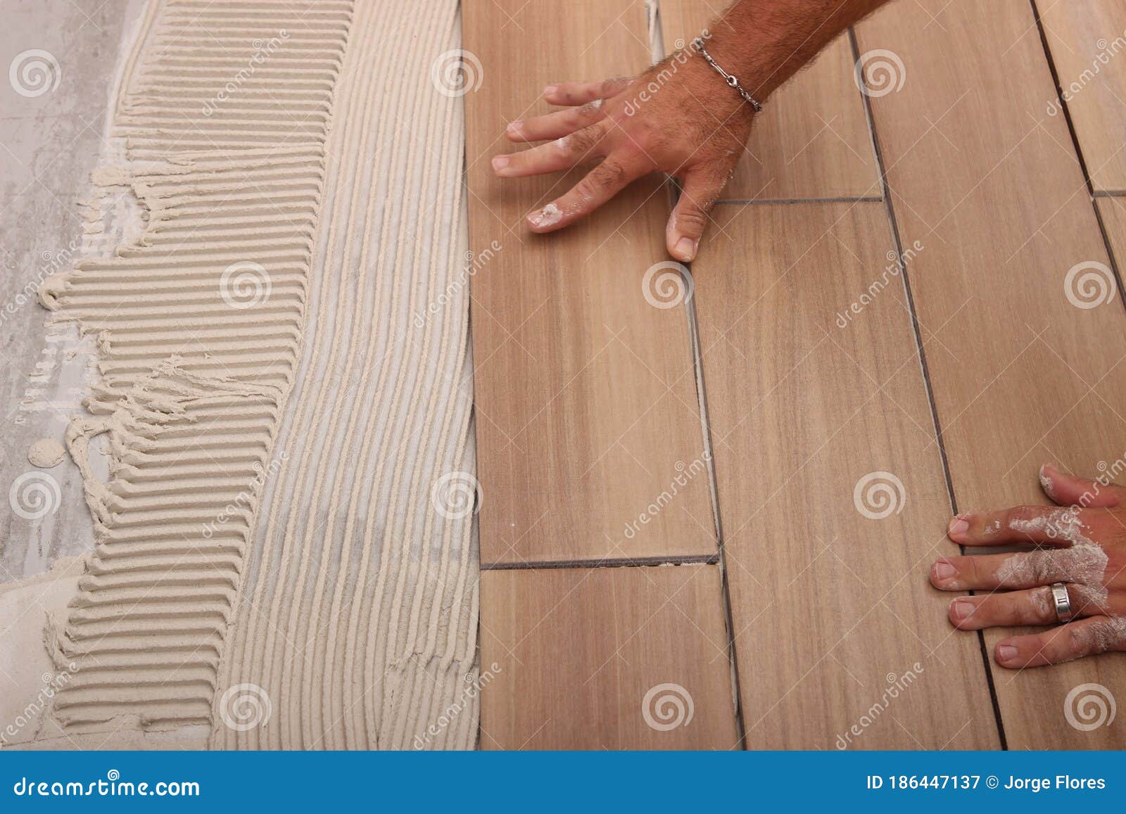 worker applying white thinset mortar