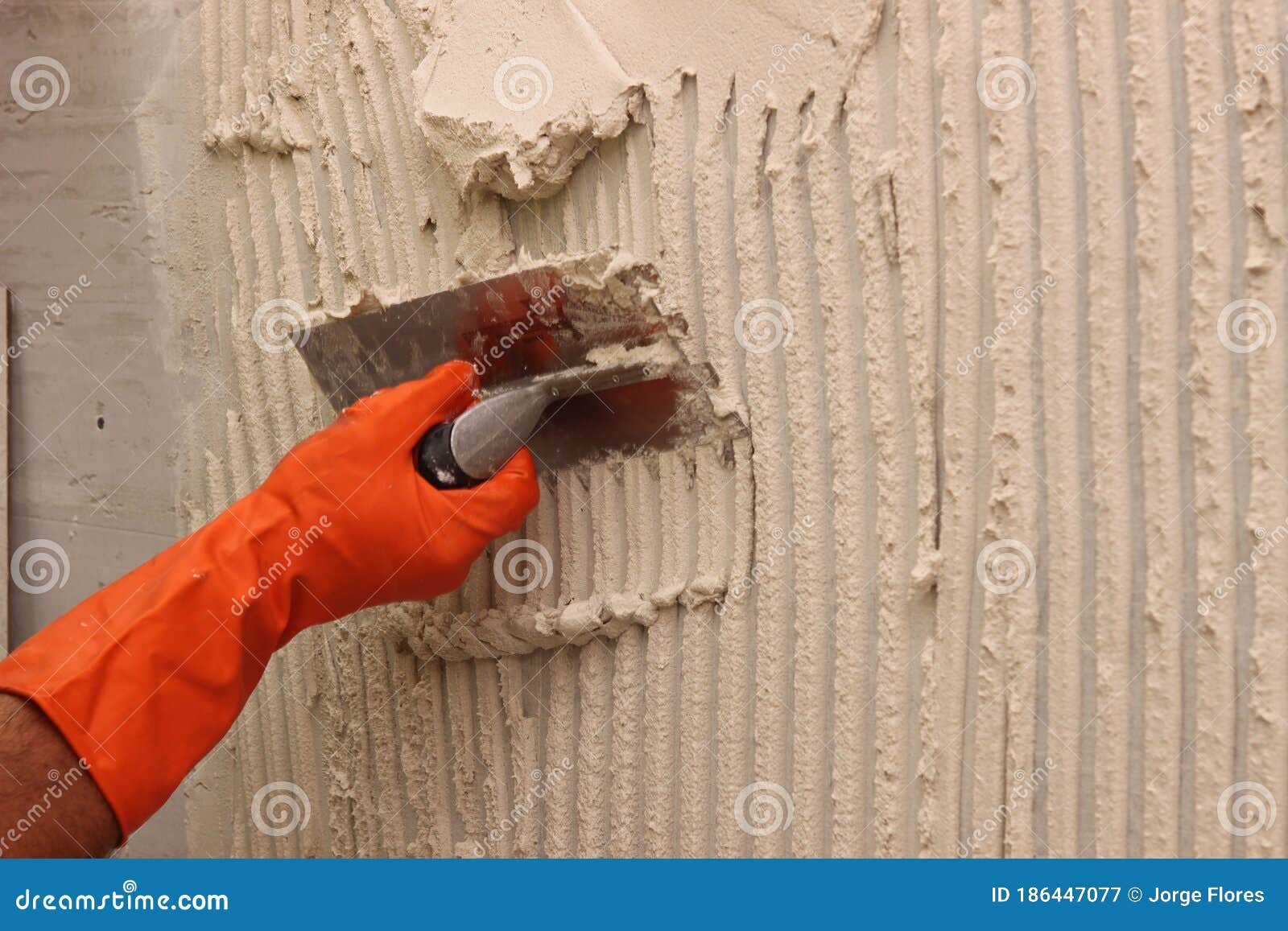 worker applying white thinset mortar