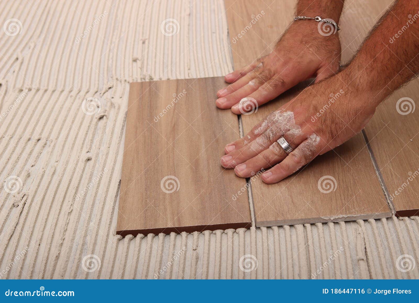 worker applying white thinset mortar