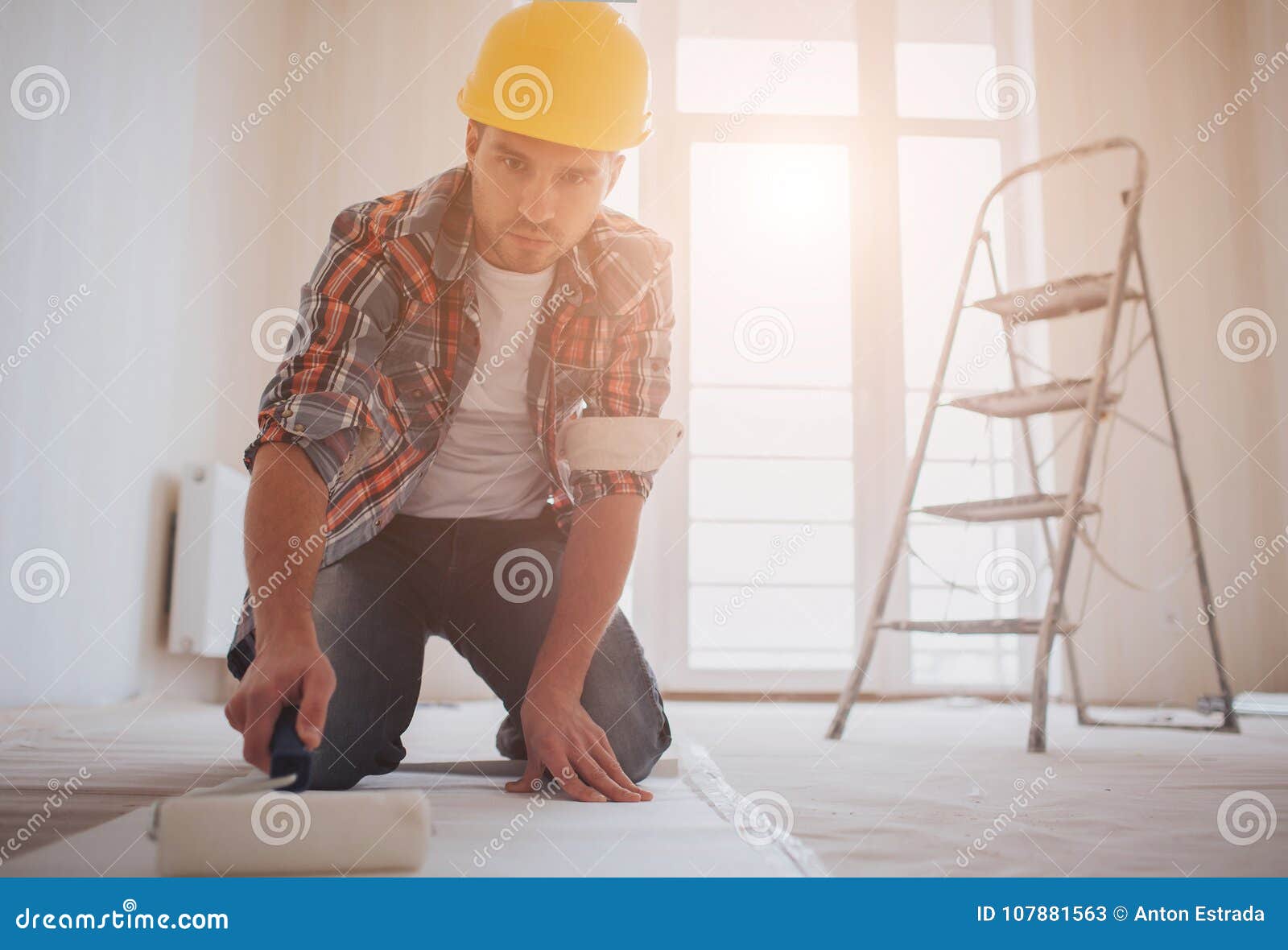 Worker Attaching Wallpaper . the Builder Puts Glue on the Wallpaper