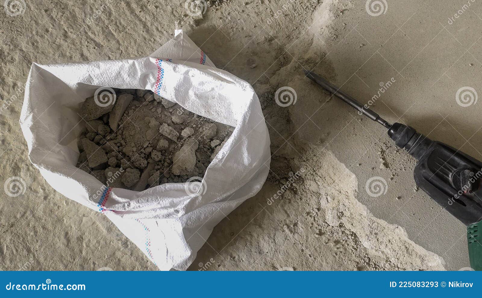 Worker Breaks the Concrete Floor with a Hammer Drill Stock Image